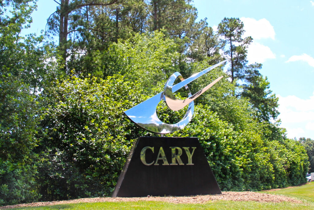 Sign for the town of Cary NC, silver sculpture on black stone base