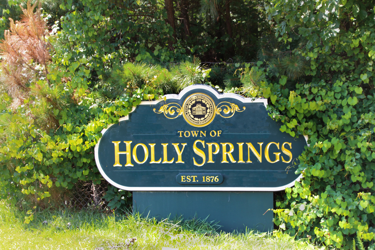 Town of Holly Springs NC sign. Green sign with gold letters